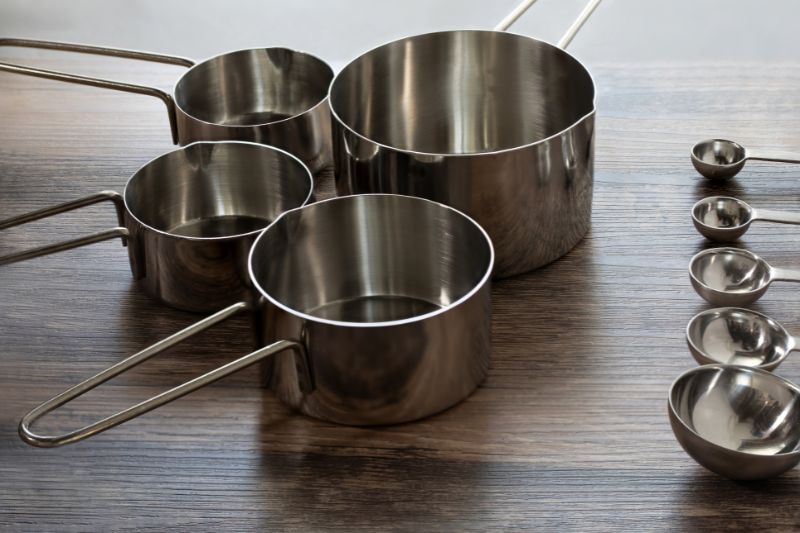 Measuring cups and mixing bowl prepared for baking ingredients