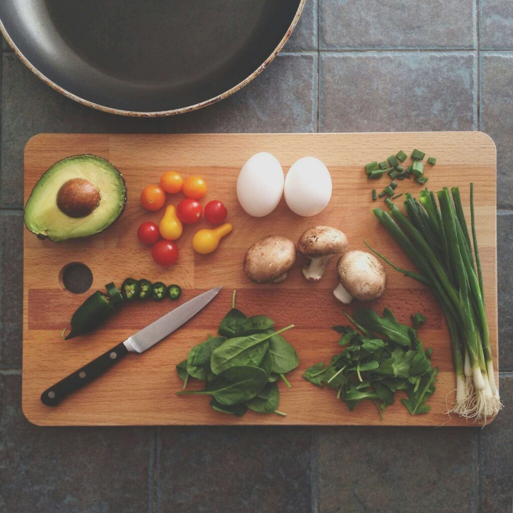Wooden cutting board with fresh vegetables in a modern kitchen