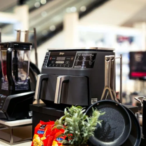 Modern kitchen countertop with premium small appliances including a coffee maker blender and toaster