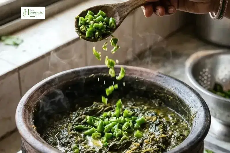 Adding green chilies to Sarson Ka Saag while cooking